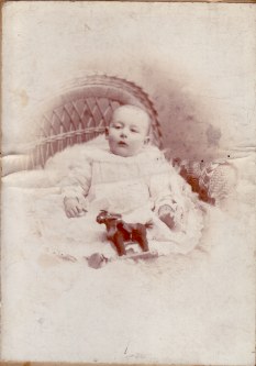 George Bird as an infant, seated in a cane chair, Watson Brothers studio, Birkenhead.